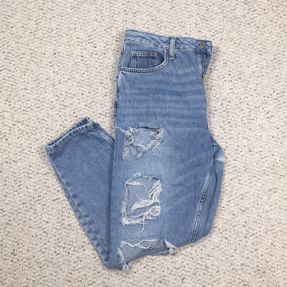Topshop moto high waisted ripped button fly jeans.